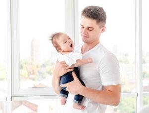 Father embracing infant