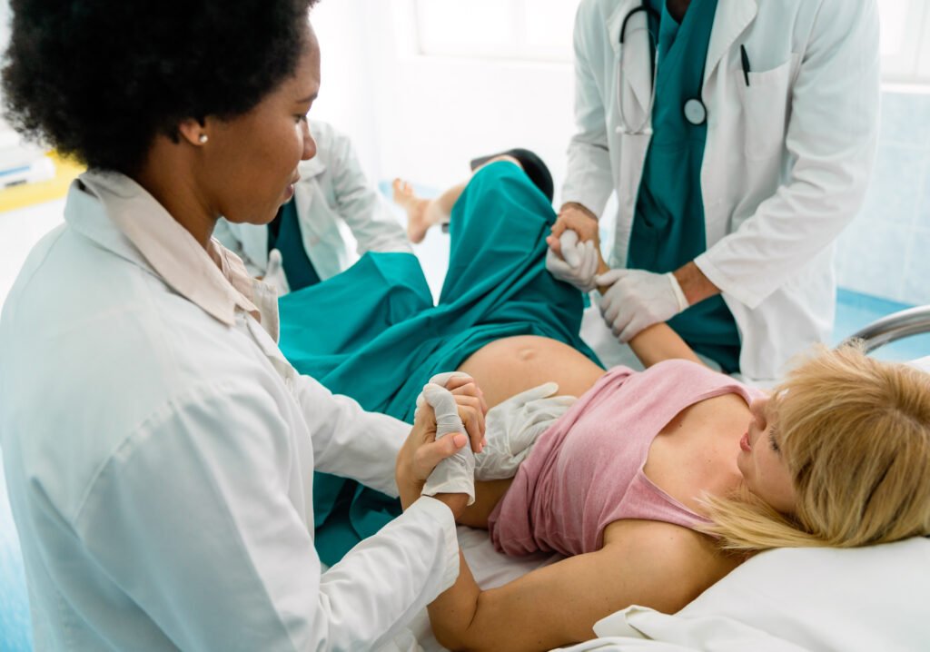 Woman giving birth in labor room of hospital